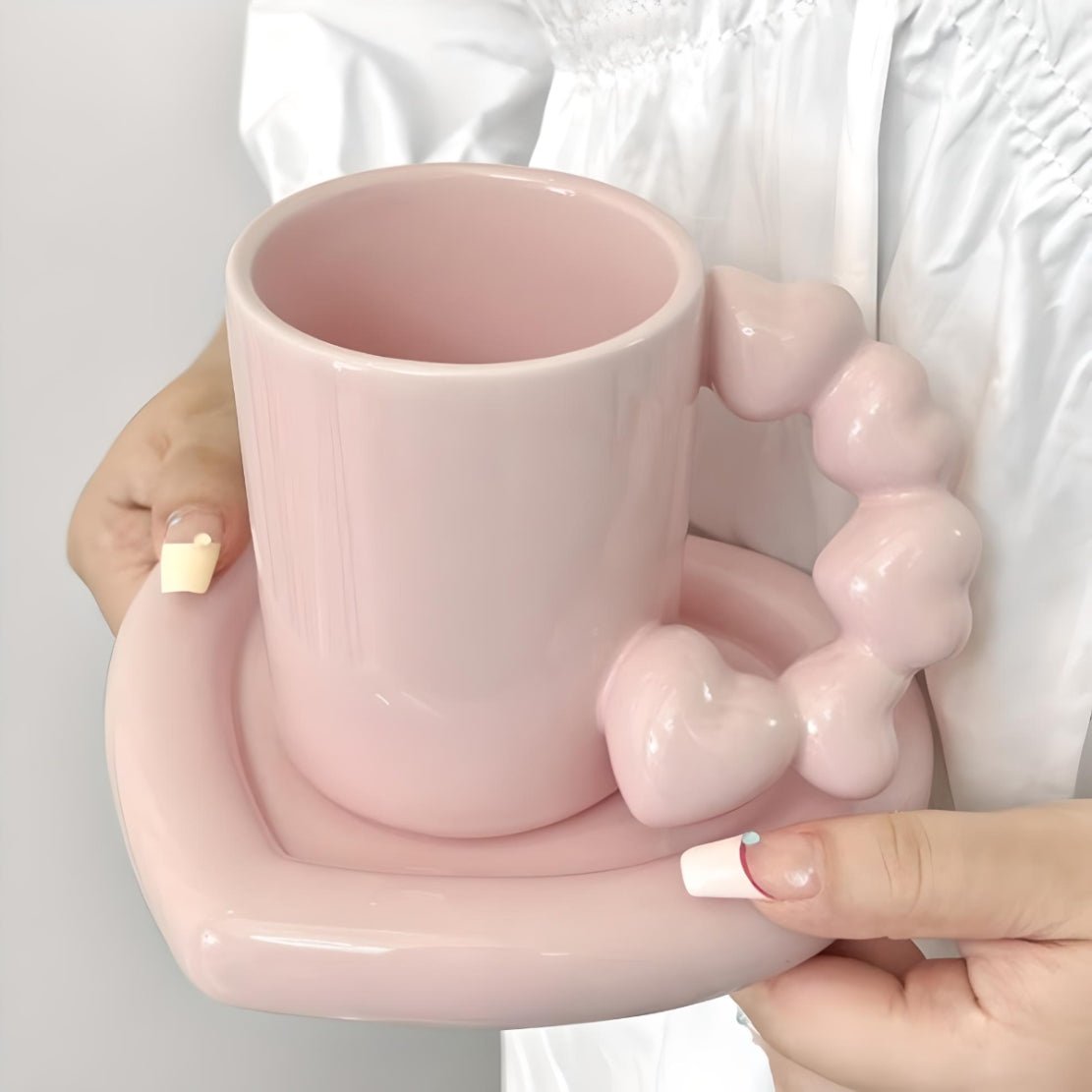 Pink, ceramic mug with heart handle and saucer