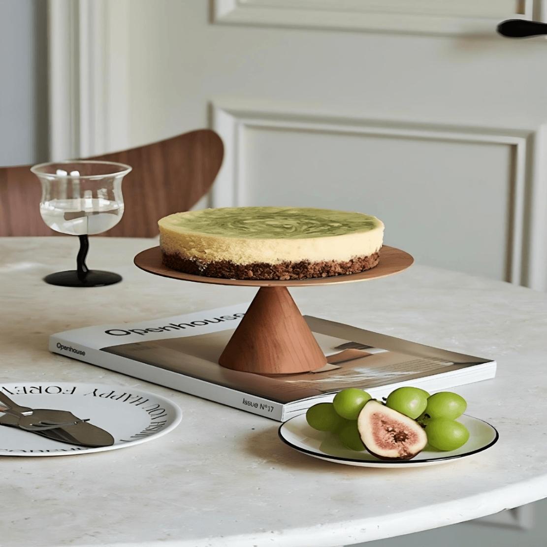 Elevated circle wood tray on dining table with cake