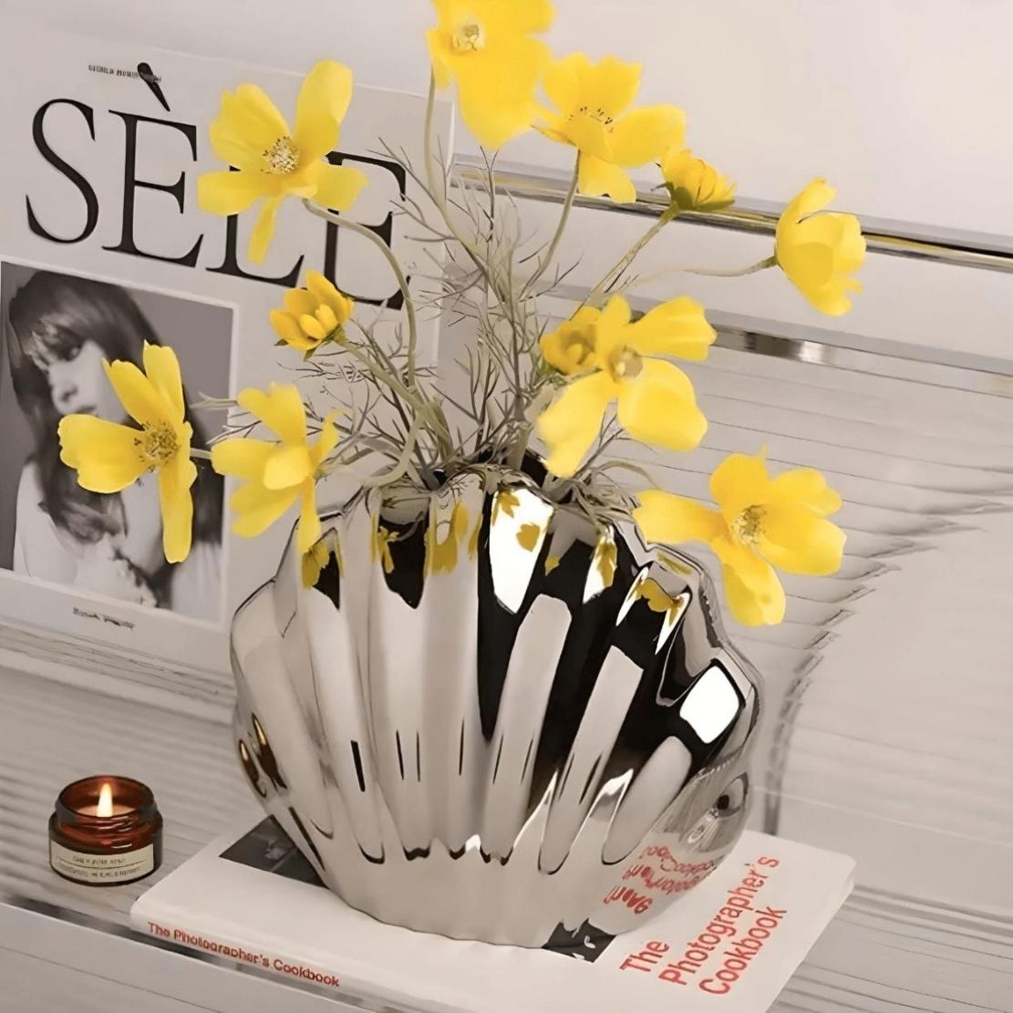 Silver glazed shell vase with yellow flowers
