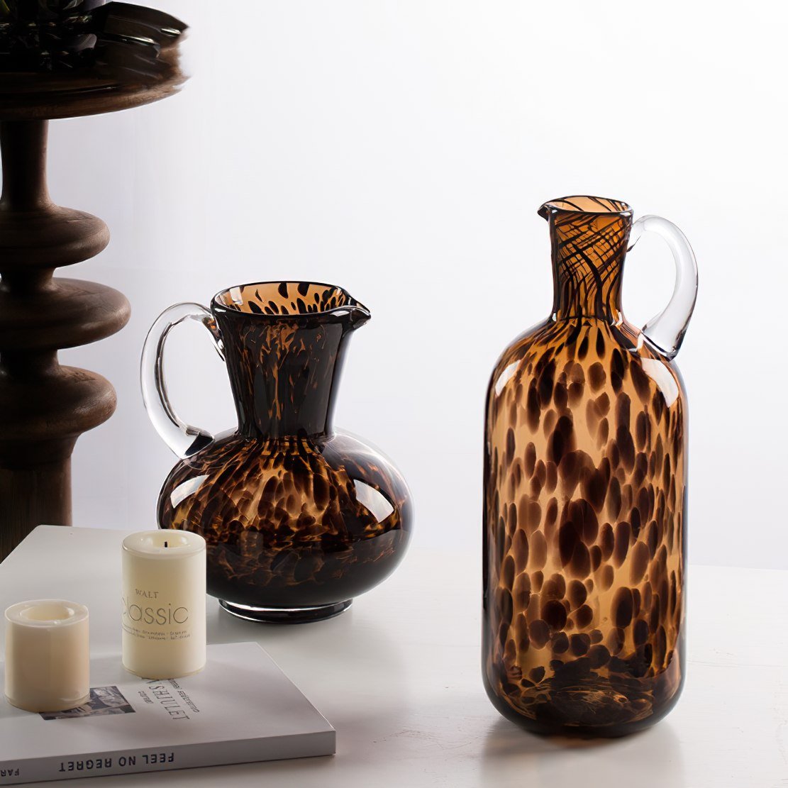 Tortoiseshell brown glass cans / vases on a tabletop
