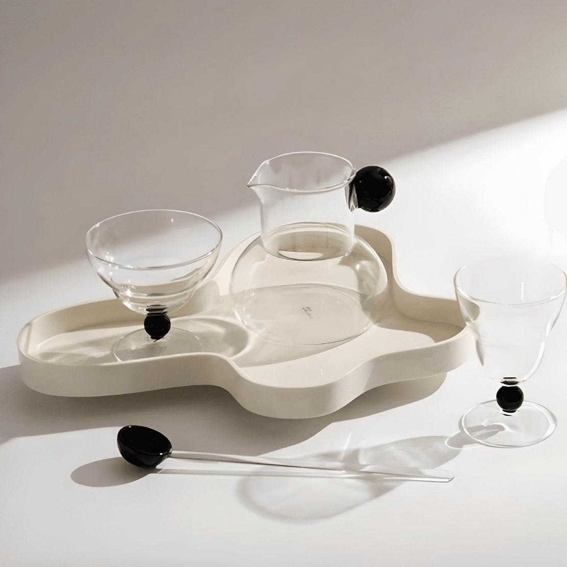 asymmetrical design white acrylic decorative storage tray with modern glassware.