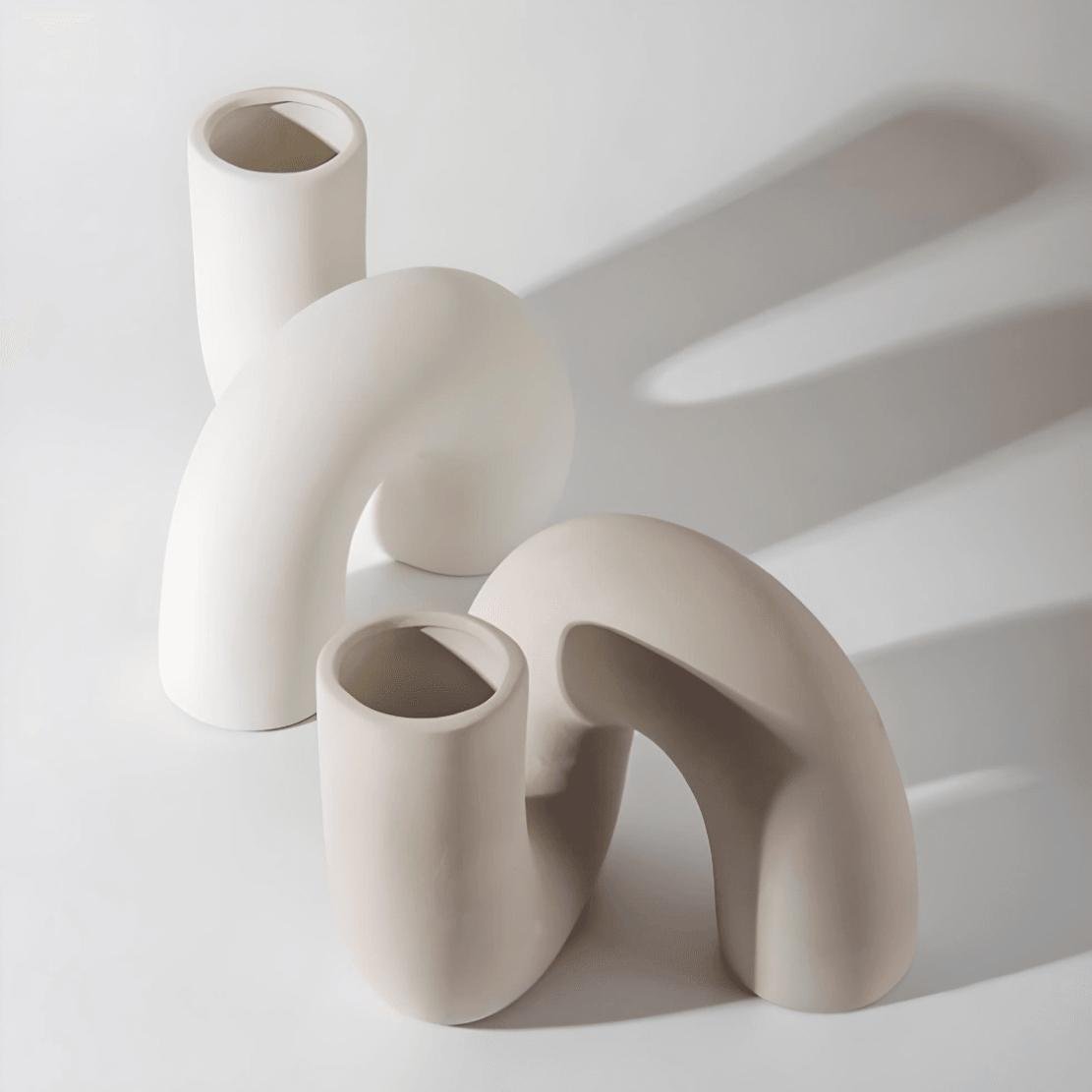 Two ceramic twist vases in white and beige