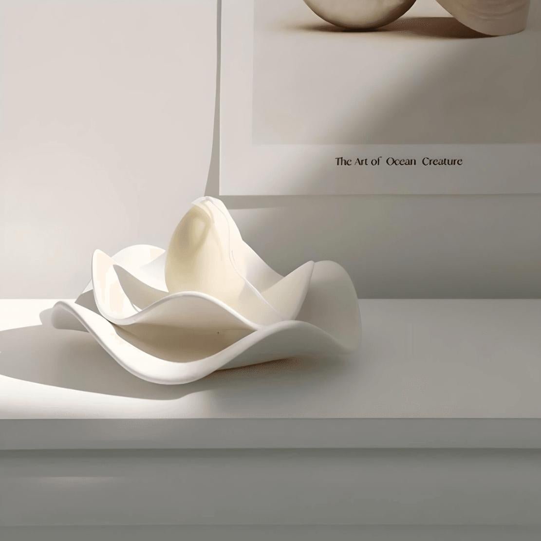White, ceramic, decorative wave bowl with candle
