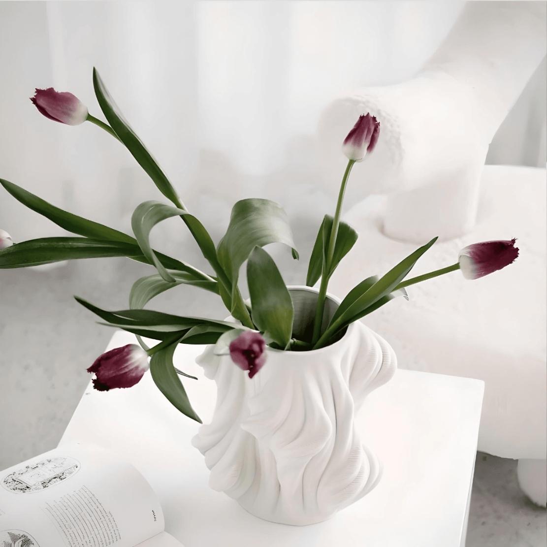 White, elegant ceramic vase with purple tulips