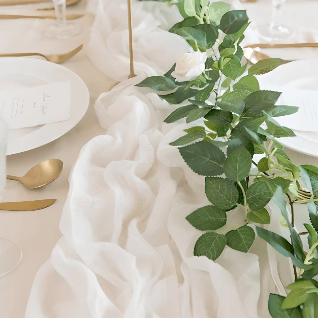 White, thin, elegant table runner with green leafs