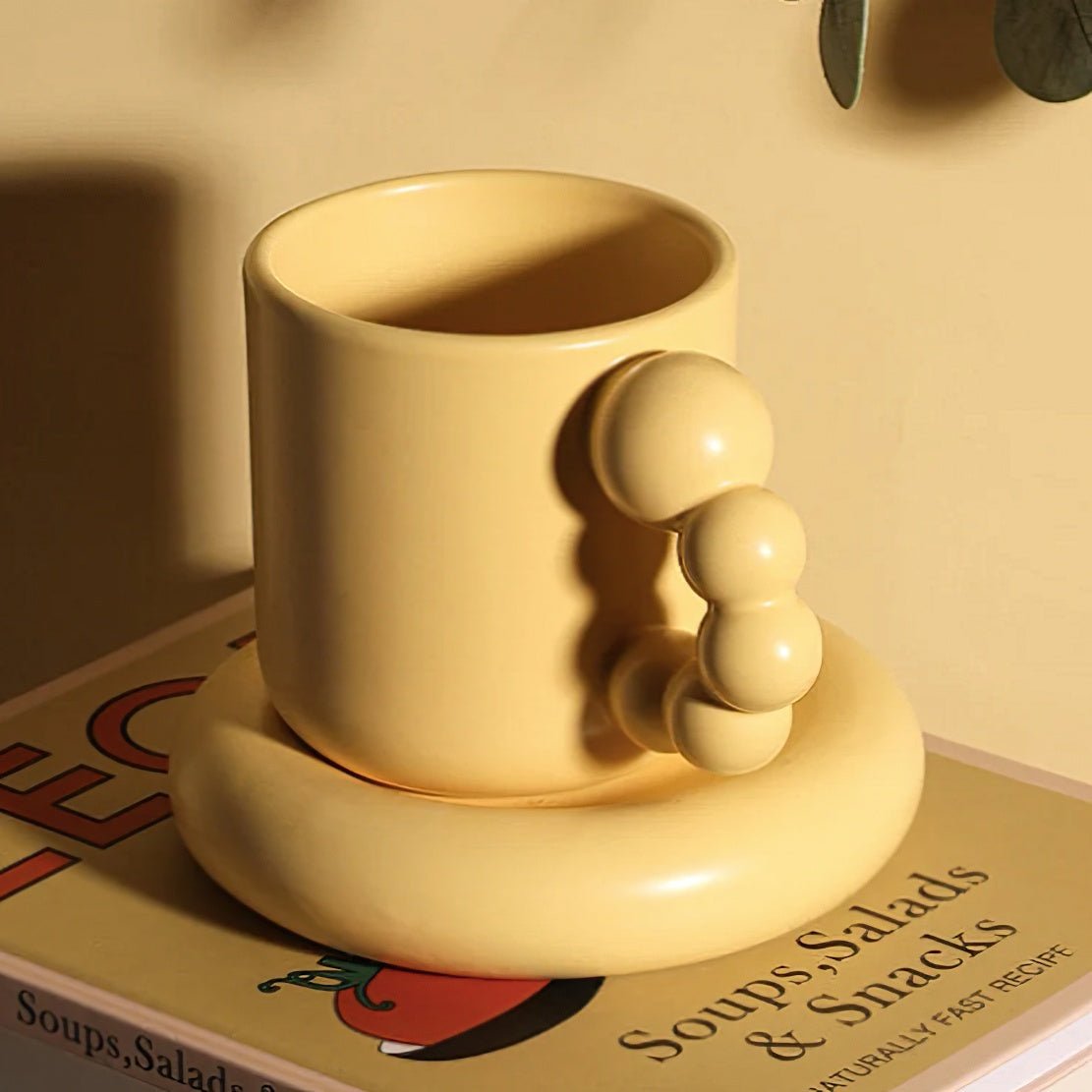 Yellow ceramic pearl handle mug with matching saucer