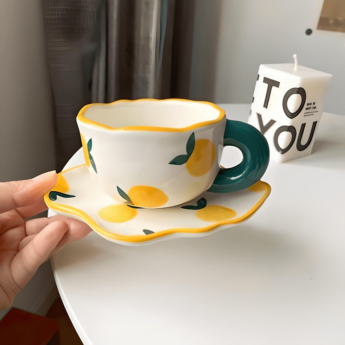 Yellow lemon pattern ceramic mug with matching saucer